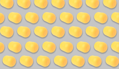 Mykolaiv, Ukraine - June 26, 2023: Yellow plastic capsule from Kinder Surprise Egg on grey background, seamless pattern design