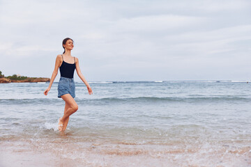 Fototapeta premium woman beach young sea summer lifestyle long smile travel sunset hair running
