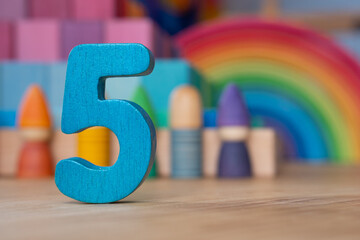 Wooden five on rainbow background