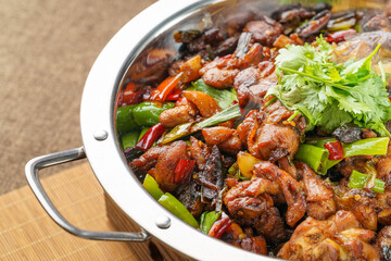 Special Sichuan cuisine griddle chicken on dark background