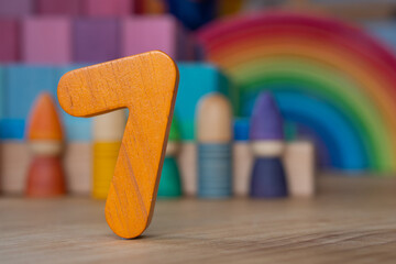 Wooden seven on rainbow background