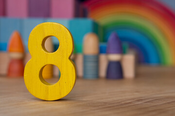 Wooden eight on rainbow background