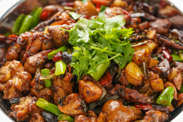 Special Sichuan cuisine griddle chicken on dark background