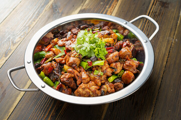 Special Sichuan cuisine griddle chicken on dark background