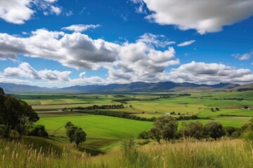 Obraz premium rolling countryside with towering range of clouds and blue sky in the distance, created with generative ai