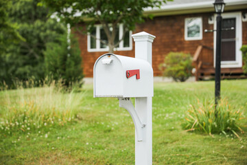 mailbox stands tall against a backdrop of greenery, symbolizing communication, connection, and the...