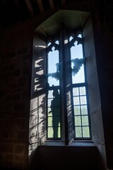 spooky ghost silhouette floating near a castle window, created with generative ai