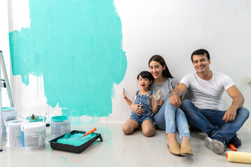Portrait of enjoy happy love asian family father and mother using a paint roller and painting...