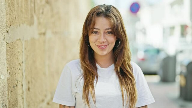 Young beautiful hispanic woman smiling confident standing at street