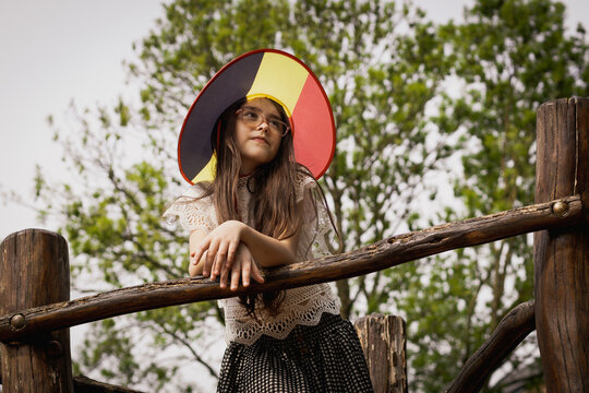 Portrait of a beautiful caucasian girl wearing a Belgian flag hat.