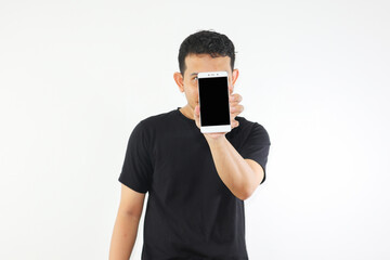 Adult Asian man showing blank mobile phone screen covering his face