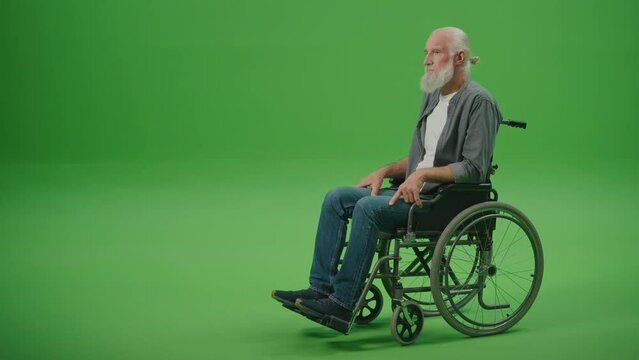 Green Screen.A Sad Old Man in a Wheelchair Feeling Lonely.Community and Social Support for Elderly People in Wheelchairs. Mental Health of the Elderly.