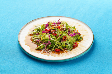 Northeast specialty cold dish small dried fish mixed with bitter chrysanthemum on monochrome background
