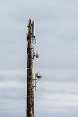 Wood pole with mobile communications antennas attached
