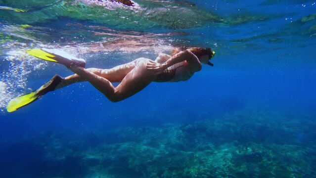 Woman Snorkeling Swimming in Blue Sea Underwater. Freedive in Ocean Water with Girl. Snorkeling and Diving in Deep Sea. Marine Life in Shallow Water. Person Swimming Near Coral Reef in Slow Motion 4k