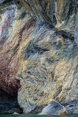 Interesting geologic feature in rock layers with colorful lichen, patterns and texture in nature, as a nature background
