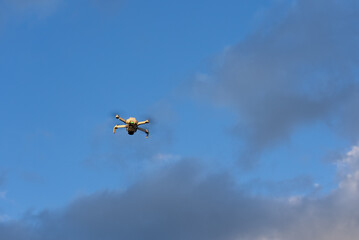 Small Drone Flying Above Blue Sky