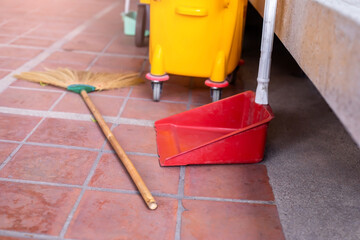 Selective focus to cleaning equipment set. Broom , powder scoop and cleaning tank.