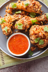 Hat Yai is a traditional chicken dish originating from Thailand, also known as Southern Thai fried chicken close-up on a plate on the table. Vertical top view from above