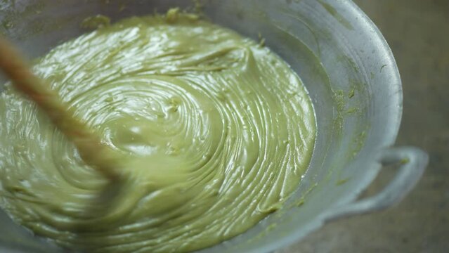cooking liquid rhombic pandan leaf stirring or freshly kanom piak poon bai toey or green coconut sweet pudding and smoke steam heat on hot pan charcoal stove by thailand nature dessert food with space