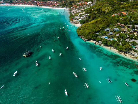 Indonesian sailing ship anchored nest to a small village in Lombok