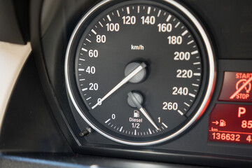 Closeup shot of a fuel gauge and speed in a car