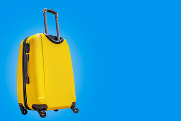 Yellow suitcase on a blue background. Travel concept. isolated