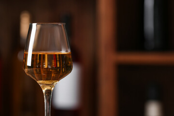 Glass of exquisite wine in cellar, closeup