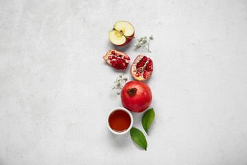 Composition with fruits, honey and gypsophila flowers on light background. Rosh hashanah (Jewish New Year) celebration