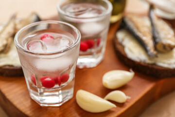 Shots with cold vodka on table