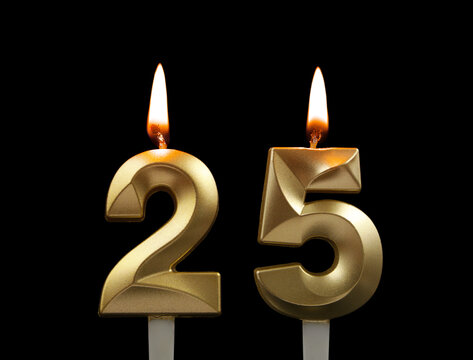 Golden birthday candles isolated on black background. Number 25.