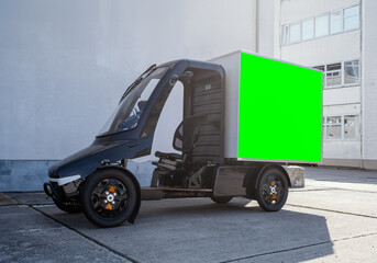 A modern electric delivery 4-wheel Quadracycle bike with a blank white cargo box with copy space...