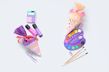 Colorful school cones with different stationery isolated on white background