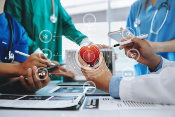 Medical technology network team meeting concept. Doctor hand working with smart phone modern digital tablet and laptop computer with graphics chart interface, with virtual icon diagram