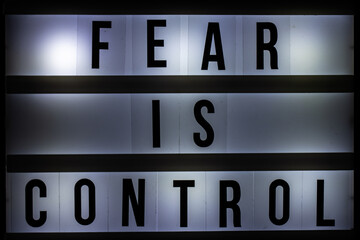 Fear Is Control text on light box