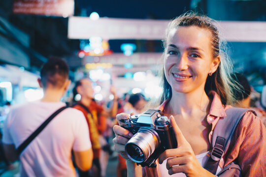 Tourist woman enjoy traveling take photo in city lifestyle chinatown street food market Bangkok