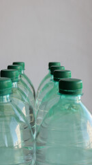 Storage of clean drinking water in plastic bottles with green caps detailed stock photo
