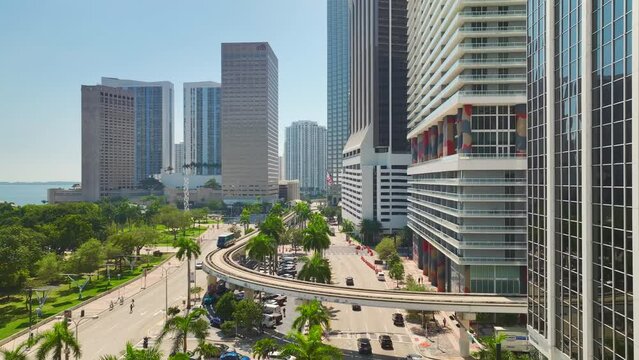 Aerial view of downtown district of Miami Brickell in Florida, USA. High skyscraper buildings and street with cars and Metrorail traffic in modern american midtown