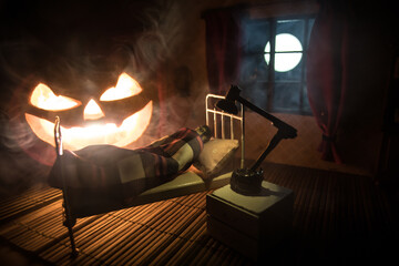 Man comfortably sleeping in his bed at night. A realistic dollhouse bedroom with furniture and window at night. Selective focus