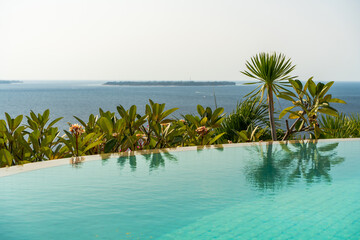 Fototapeta na wymiar Infinity pool at luxury hotel in Bali, Indonesia 