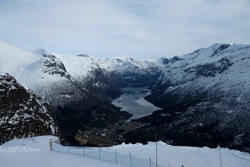 Breathtaking view of a fjord between the snow-covered mountains in Andalsnes, Norway