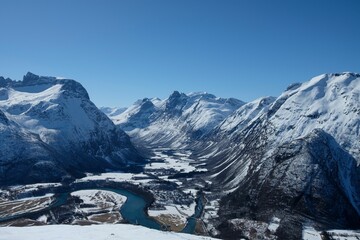 Breathtaking view of a fjord between the snow-covered mountains in Andalsnes, Norway