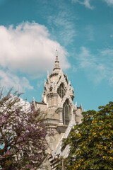 Fototapeta na wymiar Vertical shot of a beautiful gothic-style church tower in Bangkok, Thailand