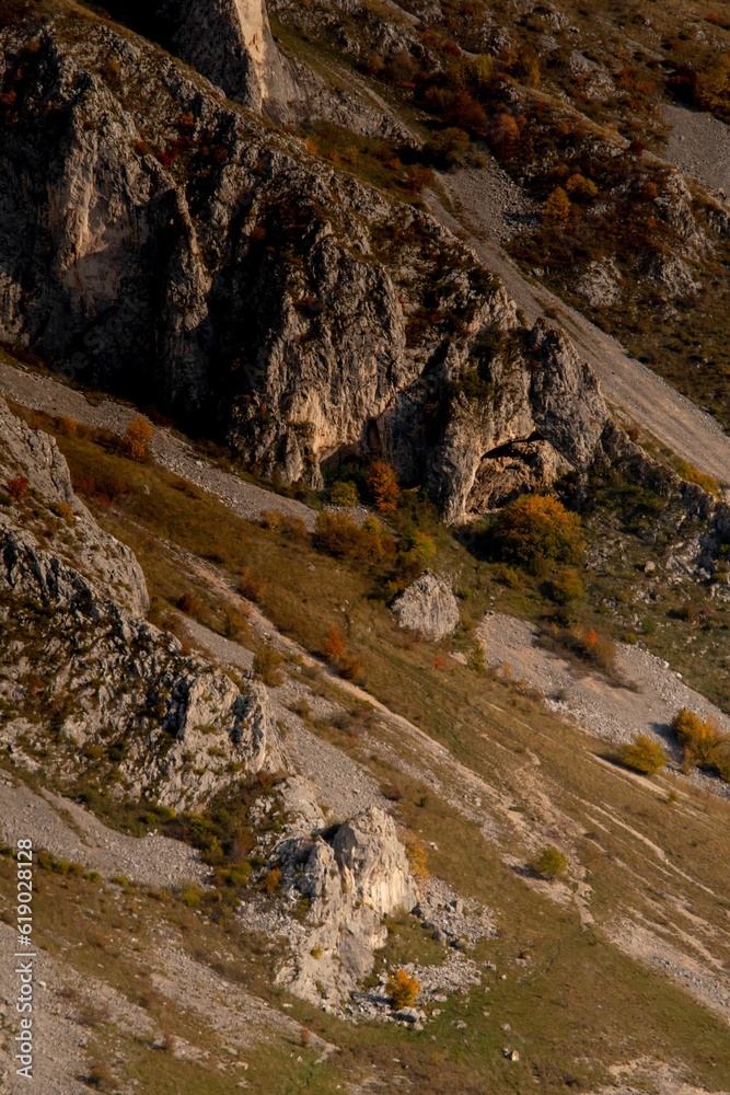 Wall mural aerial shot of the rocky big mountains and mountainsides during the autumn season