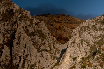 Aerial shot of the rocky big mountains and mountainsides during the autumn season