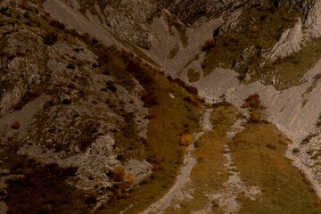 Aerial shot of the rocky big mountains and mountainsides during the autumn season