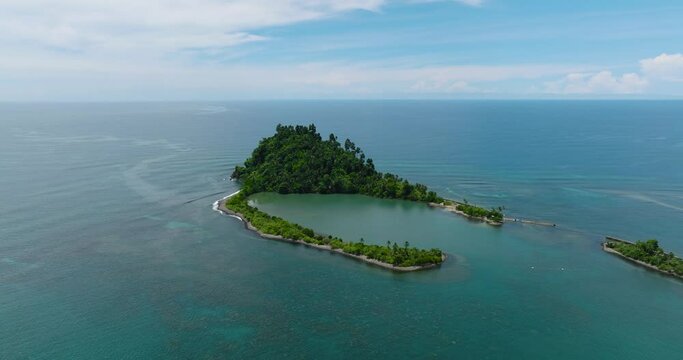 Beautiful landscape of Cabugao Island and blue sea. Blue skies and clouds. Mindanao, Philippines.