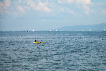 Inflatable boat, sailing ships on Lake Constance