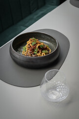 spaghetti with seafood ceramic bowl served on table soft light minimalistic 