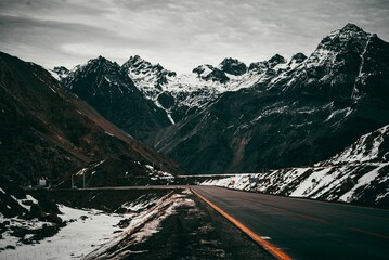 Scenic view of a winding road in Chile, through Los Andes mountains covered in snow
